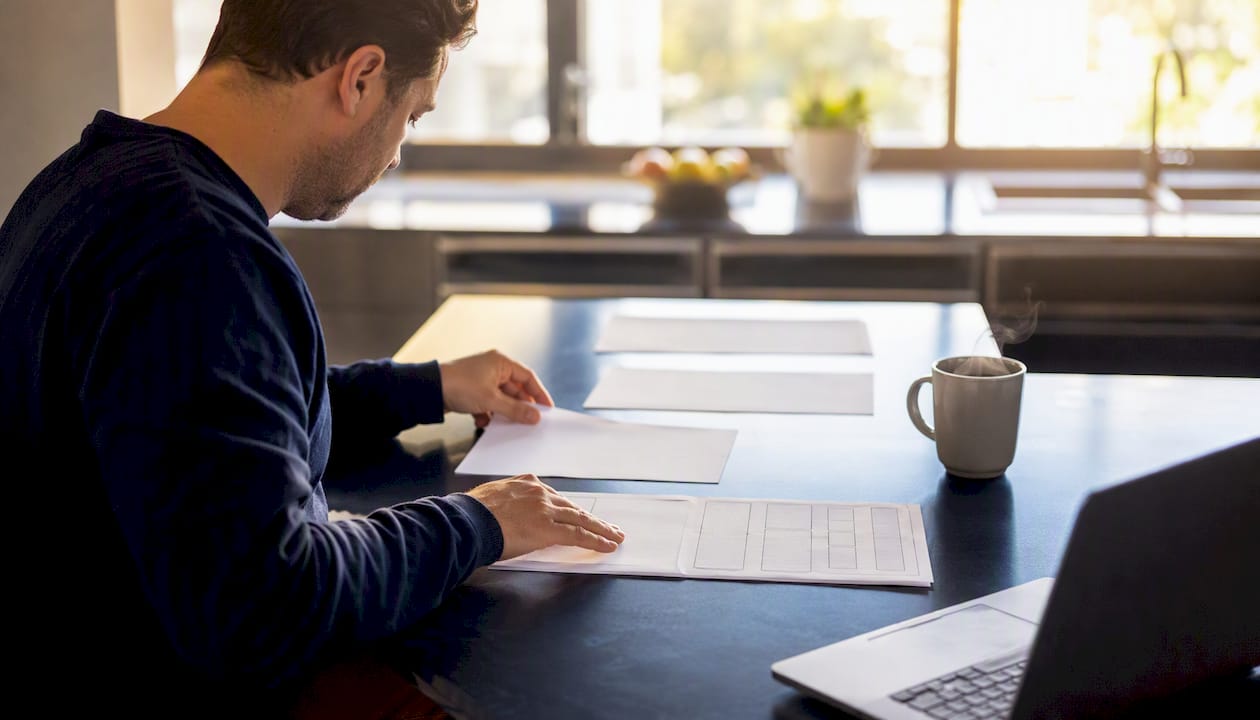 Hand organizing blank prompt templates on desk