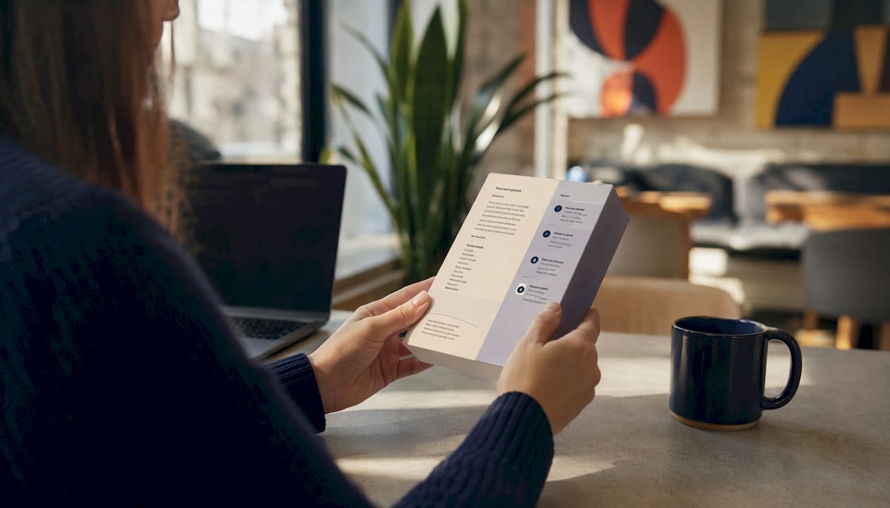 Hands comparing product feature and benefit text