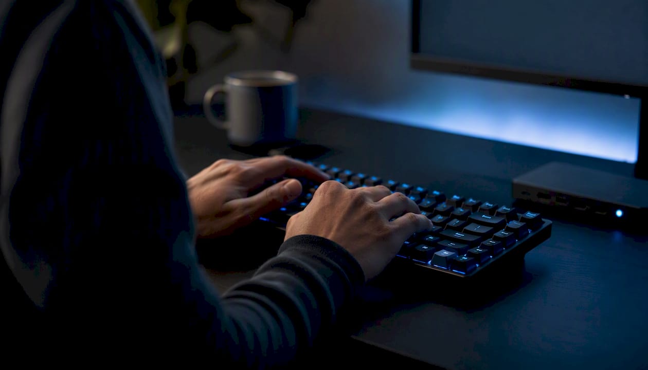 Close-up of keyboard and dark screen for HTML editing