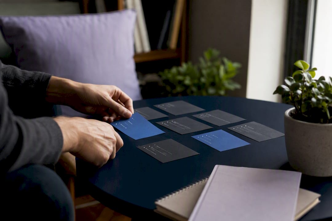 Hands arranging bullet point cards on desk